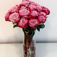 Glass vase with Magenta and Lavender Bi-Colored roses
