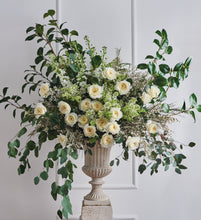 Arrangement of Patience roses with Charming milky buds ruffle out into ivory sculpted cups of delicate, lace-like petals revealing a creamy colored centre with just a hint of pale, buttery yellow.
