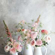 Pitchers of Keira roses and greenery - Frilly wedding-dress petals frame her cupped blooms in every shade of soft pink, from raspberry ripple to clotted cream. 
