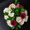 Ruscus arranged with pink and red roses