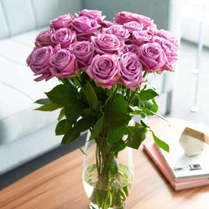 bouquet in glass vase of Purple Attraction Long Stem Roses have a hint of lavender in the center